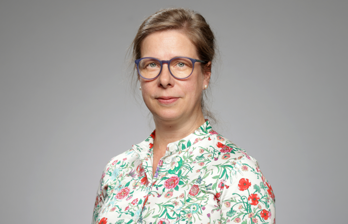 En kvinna med glasögon poserar för en bild